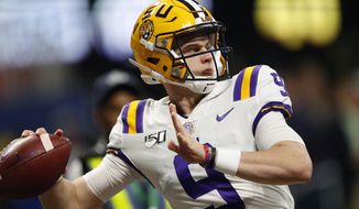 FILE - In this Dec. 7, 2019, file photo, LSU quarterback Joe Burrow (9) warms up before the Southeastern Conference championship NCAA college football game against Georgia, in Atlanta. Burrow is a unanimous selection as the offensive player of the year on The Associated Press All-Southeastern Conference football team, Monday, Dec. 9, 2019. (AP Photo/John Bazemore) ** FILE **