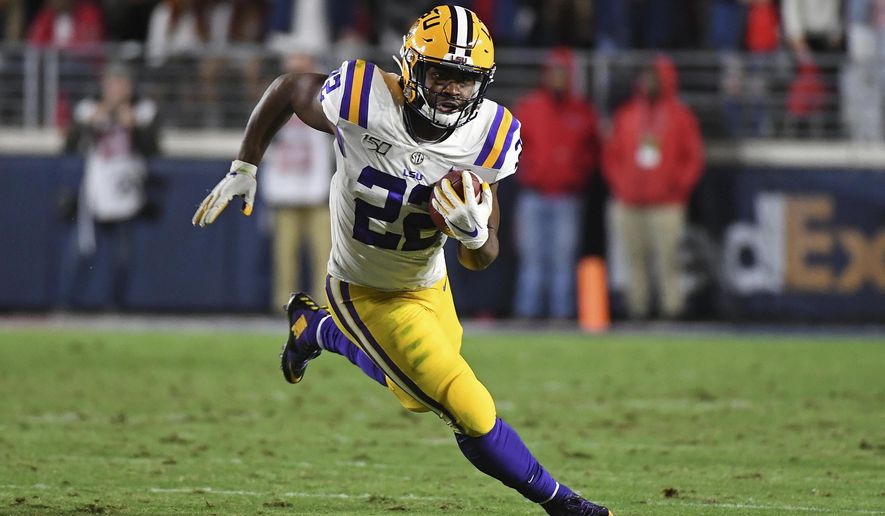 FILE - In this Nov. 16, 2019, file photo, LSU running back Clyde Edwards-Helaire (22) runs the ball during the first half of an NCAA college football game against Mississippi, in Oxford, Miss. Clyde Edwards-Helaire was one of three players from LSU’s high-powered offense to earn unanimous first-team all-SEC honors when The Associated Press All-Southeastern Conference football team was announced Monday, Dec. 9, 2019. (AP Photo/Thomas Graning, File)
