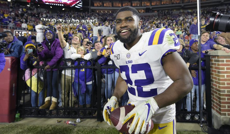 FILE - In this Nov. 9, 2019, file photo, LSU running back Clyde Edwards-Helaire (22) grins after greeting fans following an NCAA football game Saturday against Alabama, in Tuscaloosa, Ala. Clyde Edwards-Helaire was one of three players from LSU’s high-powered offense to earn unanimous first-team all-SEC honors when The Associated Press All-Southeastern Conference football team was announced Monday, Dec. 9, 2019. (AP Photo/Vasha Hunt, File)