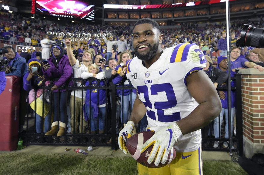 FILE - In this Nov. 9, 2019, file photo, LSU running back Clyde Edwards-Helaire (22) grins after greeting fans following an NCAA football game Saturday against Alabama, in Tuscaloosa, Ala. Clyde Edwards-Helaire was one of three players from LSU’s high-powered offense to earn unanimous first-team all-SEC honors when The Associated Press All-Southeastern Conference football team was announced Monday, Dec. 9, 2019. (AP Photo/Vasha Hunt, File)