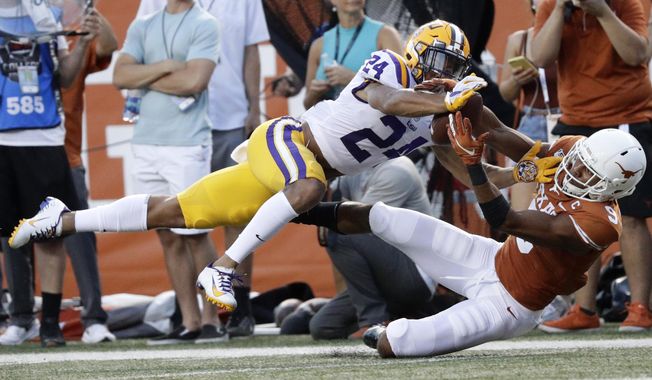 FILE - In this Sept. 7, 2019, file photo, LSU cornerback Derek Stingley Jr., left, breaks up a pass intended for Texas wide receiver Collin Johnson during the first half of an NCAA college football game, in Austin, Texas. Stingley was selected as newcomer of the year on The Associated Press All-Southeastern Conference football team, Monday, Dec. 9, 2019. (AP Photo/Eric Gay, File)