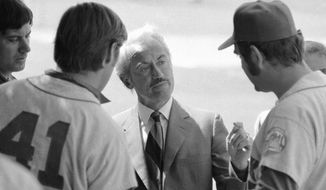 FILE - This March 11, 1972, file photo shows Marvin Miller, executive director of the Major League Players Association, talking to New York Mets&#39; Tom Seaver (41), and Ed Kranepool, in St. Petersburg, Fla. Miller, the union leader who revolutionized baseball by empowering players to negotiate multimillion-dollar contracts and to play for teams of their own choosing, was elected to baseball&#39;s Hall of Fame on Sunday, Dec. 8, 2019. (AP Photo/File)