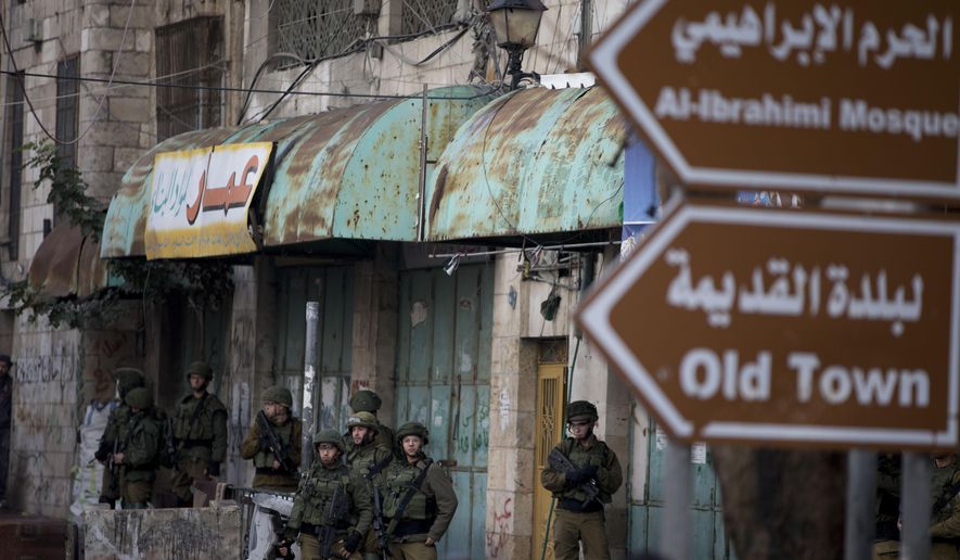 Israeli troops take their position during clashes with Palestinian demonstrators during a protest over Israeli settlement activity Monday, Dec. 9, 2019, in the West Bank city of Hebron. (AP Photo/Majdi Mohammed)