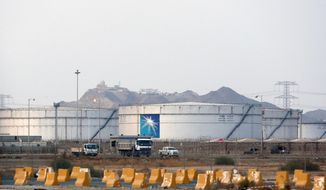This Sept. 15, 2019, file photo, shows storage tanks at the North Jiddah bulk plant, an Aramco oil facility, in Jiddah, Saudi Arabia. Saudi Arabia&#39;s state-owned oil company Aramco on Thursday, Dec. 5, 2019, set a share price for its IPO — expected to be the biggest ever — that puts the value of the company at $1.7 trillion, more than Apple or Microsoft. (AP Photo/Amr Nabil, File)