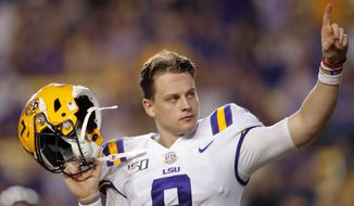 LSU quarterback Joe Burrow, who is considered a frontrunner for the Heisman Trophy, acknowledges the crowd as he is pulled from his last game in Tiger Stadium, in the fourth quarter of the team&#39;s NCAA college football game against Texas A&amp;amp;M in Baton Rouge, La., Saturday, Nov. 30, 2019. LSU won 50-7. (AP Photo/Gerald Herbert)
