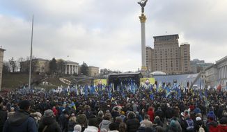 Activists attend a rally in central Kyiv, Ukraine, Sunday, Dec. 8, 2019. Several thousand people rallied Sunday in the Ukrainian capital of Kyiv to demand that the president defend the country&#39;s interests in this week&#39;s summit with Russia, Germany and France on ending the war in eastern Ukraine.  (AP Photo/Efrem Lukatsky)