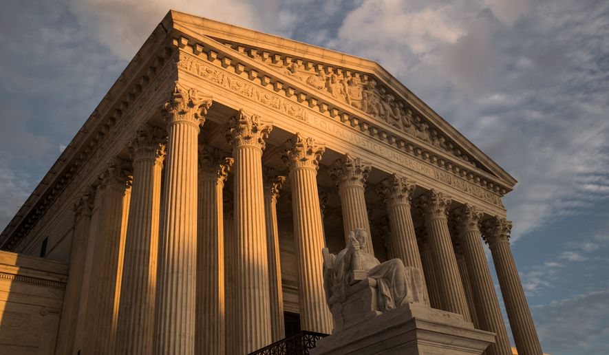 FILE — In this Oct. 10, 2017, file photo, the Supreme Court in Washington, at sunset. The Supreme Court has left in place a Kentucky law requiring doctors to perform ultrasounds and show fetal images to patients before abortions. The justices did not comment on Monday, Dec. 9, 2019, in refusing to review an appeals court ruling that upheld the law. (AP Photo/J. Scott Applewhite, File)