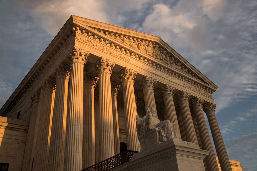 FILE — In this Oct. 10, 2017, file photo, the Supreme Court in Washington, at sunset. The Supreme Court has left in place a Kentucky law requiring doctors to perform ultrasounds and show fetal images to patients before abortions. The justices did not comment on Monday, Dec. 9, 2019, in refusing to review an appeals court ruling that upheld the law. (AP Photo/J. Scott Applewhite, File)