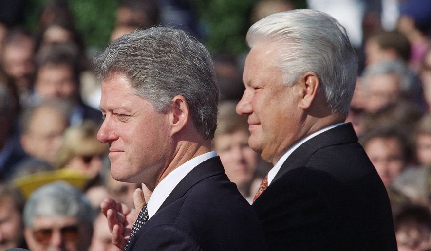 President Bill Clinton and Russian President Boris Yeltsin during an arrival ceremony for the Russian president on the South Lawn of the White House in Washington, Sept. 27, 1994. (AP Photo/Joe Marquette)