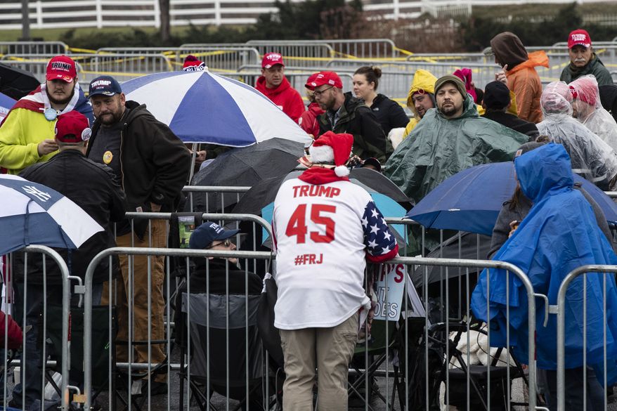 People wait in line to attend this evening's President Donald Trump campaign rally in Hershey, Pa., Tuesday, Dec. 10, 2019. (AP Photo/Matt Rourke)