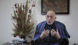 Former Afghan President Hamid Karzai speaks during an interview with The Associated Press, in Kabul, Afghanistan, Tuesday, Dec. 10, 2019. Karzai, whose final years in power were characterized by a cantankerous relationship with the United States, said on Tuesday that Washington used blackmail and corruption to manipulate his officials, undermine his government and foment violence among the country&#39;s many factions. (AP Photo/Altaf Qadri)