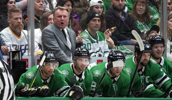 Dallas Stars interim head coach Rick Bowness yells to his players in the first period of an NHL hockey game against the New Jersey Devils, Tuesday, Dec. 10, 2019, in Dallas. Bowness was announced as interim head coach earlier in the day after former head coach Jim Montgomery was fired for &amp;quot;unprofessional conduct.&amp;quot; (AP Photo/Jeffrey McWhorter)