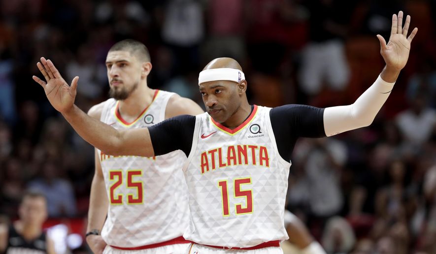 Atlanta Hawks guard Vince Carter (15) acknowledges the crowd as he is introduced during the first half of an NBA basketball game against the Miami Heat, Tuesday, Dec. 10, 2019, in Miami. (AP Photo/Lynne Sladky)