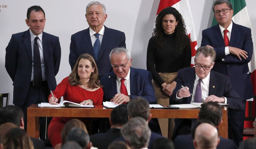 Deputy Prime Minister of Canada Chrystia Freeland, left, Mexico&#39;s top trade negotiator Jesus Seade, center, and U.S. Trade Representative Robert Lighthizer, sign an update to the North American Free Trade Agreement, at the national palace in Mexico City, Tuesday, Dec. 10. 2019. Observing from behind are Mexico&#39;s Treasury Secretary Arturo Herrera, left, Mexico&#39;s President Andres Manuel Lopez Obrador, second left, Mexico&#39;s Labor Secretary Maria Alcade, third left, and The President of the Mexican Senate Ricardo Monreal. (AP Photo/Marco Ugarte)