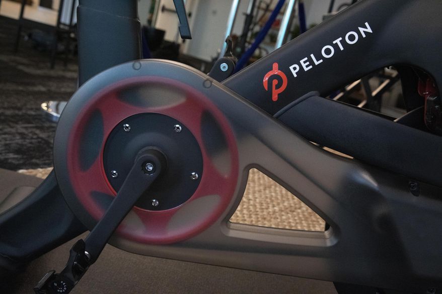 File-This Sept. 26, 2019, file photo shows the Peloton logo on the company&#39;s stationary bicycle in New York. Shares of exercise bike company Peloton were under pressure Tuesday, Dec. 10, 2019, from a scathing research report that comes on the heels of blowback from its widely mocked ad. Andrew Left of Citron Research is well known on Wall Street for targeting companies he thinks have flawed business models and placing bets that their stocks will fall. He&#39;s now taking aim at New York-based Peloton Interactive Inc. He put a price target of $5 on the stock Tuesday. That would be an 86% drop from where it stood at the close of trading Monday. Peloton went public in September at $29 a share. The stock was down $2.45, or 7%, at $32.32 in afternoon trading Tuesday. (AP Photo/Mark Lennihan, File)