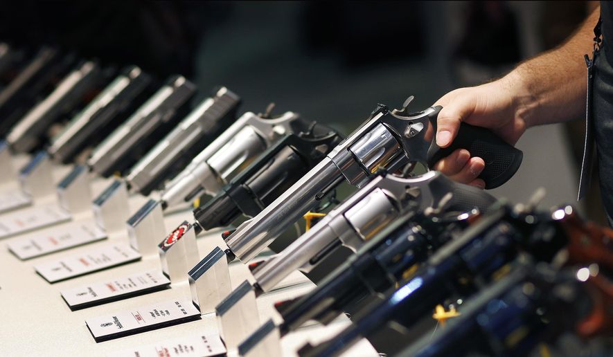 Handguns are displayed at the Shooting, Hunting and Outdoor Trade Show in Las Vegas, Jan. 19, 2016. (AP Photo/John Locher) ** FILE ** 