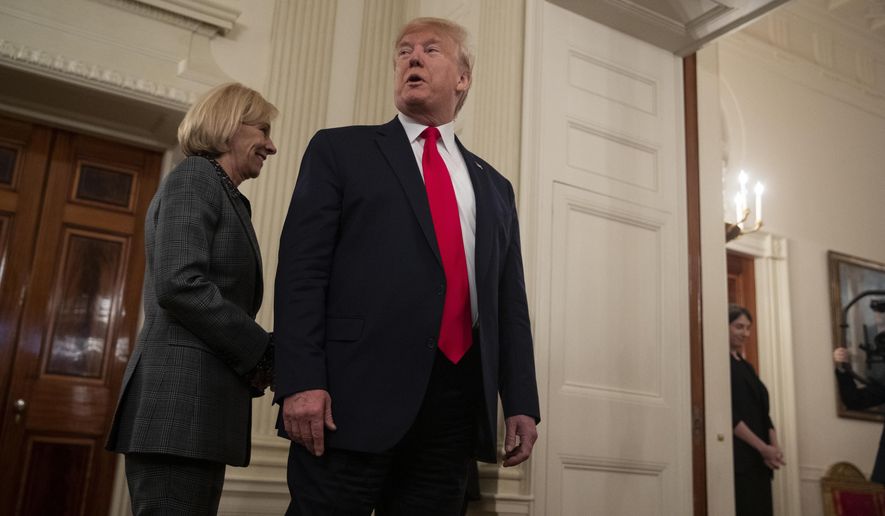 Secretary of Education Betsy DeVos follows President Donald Trump as they leave NCAA Collegiate National Champions Day at the White House, Friday, Nov. 22, 2019, in Washington. (AP Photo/ Evan Vucci)