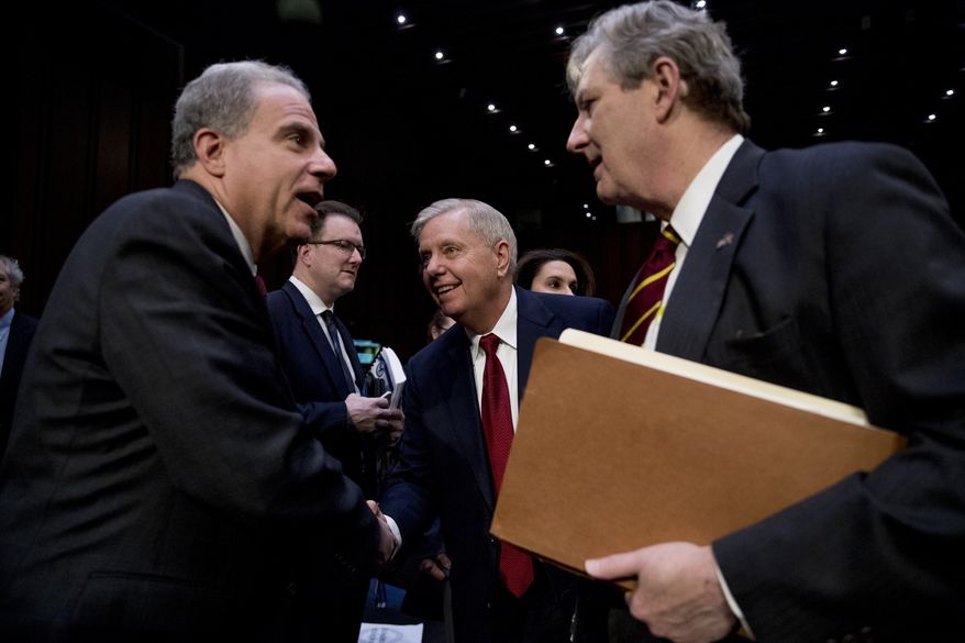 Department of Justice Inspector General Michael Horowitz, left, speaks with Chairman Lindsey Graham, R-S.C., center, and Sen. John Kennedy, R-La., right, after testifying at a Senate Judiciary Committee hearing on the inspector general&#39;s report on alleged abuses of the Foreign Intelligence Surveillance Act, Wednesday, Dec. 11, 2019, on Capitol Hill in Washington. (AP Photo/Andrew Harnik)