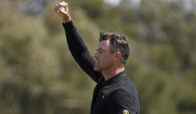 International team player Adam Scott of Australia celebrates a win over the U.S. during their fourball match at the Royal Melbourne Golf Club in the opening rounds of the President&#x27;s Cup golf tournament in Melbourne, Thursday, Dec. 12, 2019. (AP Photo/Andy Brownbill)
