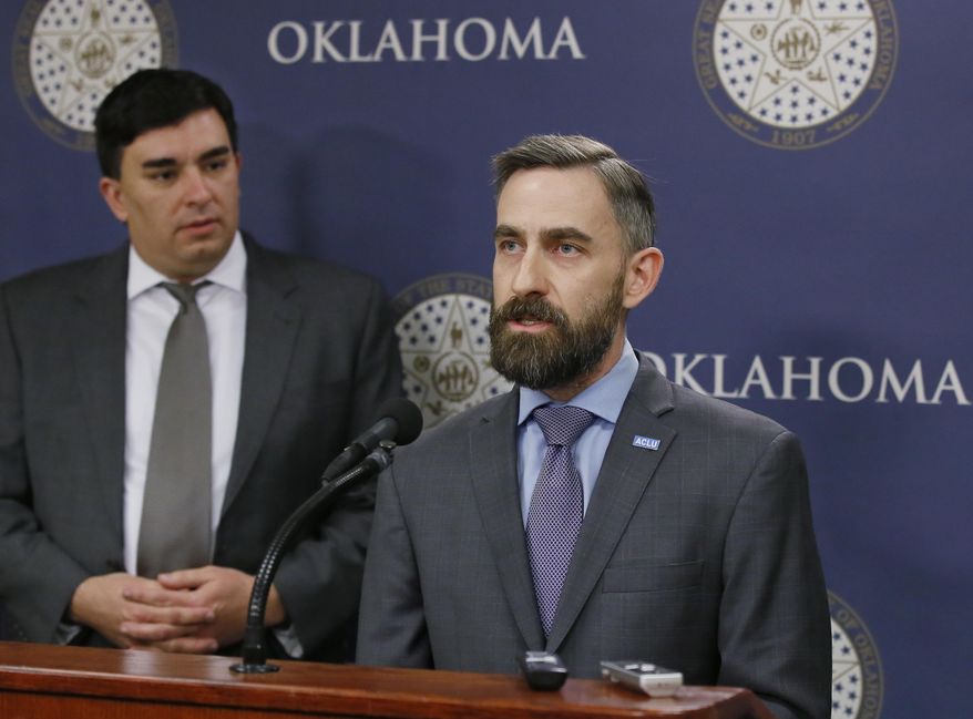 FILE - In this Feb. 7, 2017 file photo, Ryan Kiesel, right, Executive Director of the American Civil Liberties Union of Oklahoma, speaks during a news conference in Oklahoma City. At left is Brady Henderson, Legal Director. The American Civil Liberties Union of Oklahoma has filed a federal class-action lawsuit Tuesday, Dec. 10, 2019, against court officials in Canadian County, alleging their bail system unconstitutionally discriminates against poor and disabled people. (AP Photo/Sue Ogrocki, File)