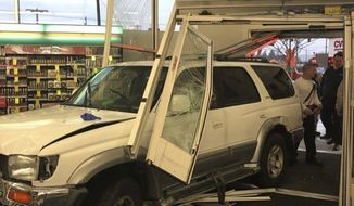 This photo provided by Salisbury Fire Department shows an SUV that crashed inside a CVS pharmacy in Salisbury, Md., on Tuesday Dec. 10, 2019.   A CVS customer and the driver of the SUV were taken to a hospital for treatment of non-life-threatening injuries. Salisbury police Capt. Rich Kaiser said the driver may have suffered a medical emergency which led to the crash.   (Salisbury Fire Department via AP)