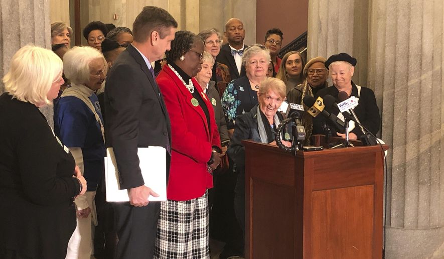 Tootsie Holland speaks to a crowd supporting he Equal Rights Amendment at a rally calling for South Carolina to become the critical 38th state to pass the amendment to the U.S. Constitution as proposal sponsors state Sen. Tom Davis and state Rep. Gilda Cobb-Hunter listen at a Statehouse gathering on Wednesday, Dec. 11, 2019, in Columbia, South Carolina. Holland pushed for the amendment when it was first proposed back in 1972. (AP Photo/Jeffrey Collins)