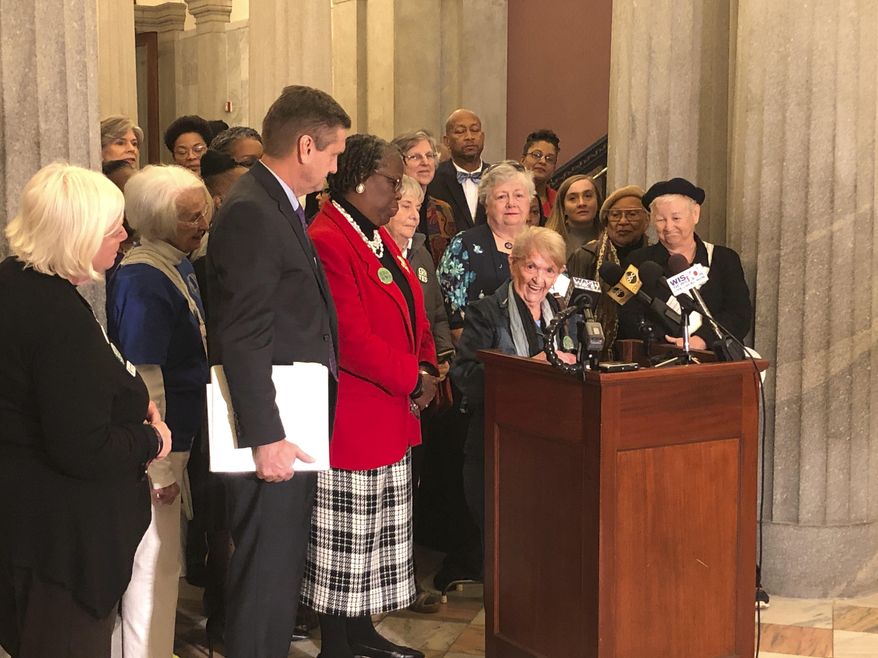 Tootsie Holland speaks to a crowd supporting he Equal Rights Amendment at a rally calling for South Carolina to become the critical 38th state to pass the amendment to the U.S. Constitution as proposal sponsors state Sen. Tom Davis and state Rep. Gilda Cobb-Hunter listen at a Statehouse gathering on Wednesday, Dec. 11, 2019, in Columbia, South Carolina. Holland pushed for the amendment when it was first proposed back in 1972. (AP Photo/Jeffrey Collins)