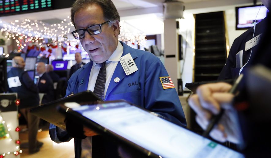 Trader Sal Suarino works on the floor of the New York Stock Exchange, Wednesday, Dec. 11, 2019. Stocks are opening mixed on Wall Street following news reports that US President Donald Trump might delay a tariff hike on Chinese goods set to go into effect this weekend. (AP Photo/Richard Drew)