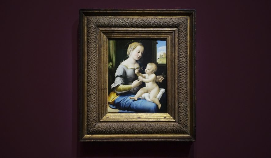 The painting ‚Madonna of the Pinks&#x27; of Renaissance artist Raphael from London&#x27;s National Gallery is on display at an exhibition at the Gemaeldegalerie in Berlin, Wednesday, Germany, Dec. 11, 2019. Berlin is opening the first of several Raphael exhibitions as the art world celebrates the 500th anniversary of his death next year. The show is dedicated to five famous Madonna paintings by the renowned Renaissance master that belong to Berlin&#x27;s Gemaeldegalerie collections and another masterpiece of the Virgin Mary that is on loan from the National Gallery in London. (AP Photo/Markus Schreiber)