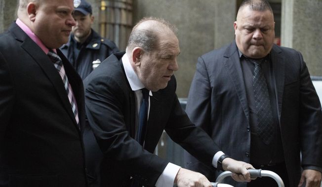 Harvey Weinstein, center, arrives for a court hearing, Wednesday, Dec. 11, 2019 in New York. (AP Photo/Mark Lennihan)