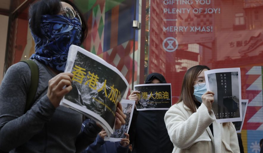 Pro-democracy supporters and office workers protest in Causeway Bay in Hong Kong, Wednesday, Dec. 11, 2019. Hong Kong Chief Executive Carrie Lam on Tuesday again ruled out further concessions to protesters who marched peacefully in their hundreds of thousands this past weekend, days before she is to travel to Beijing for regularly scheduled meetings with Communist Party leaders. (AP Photo/Mark Schiefelbein)