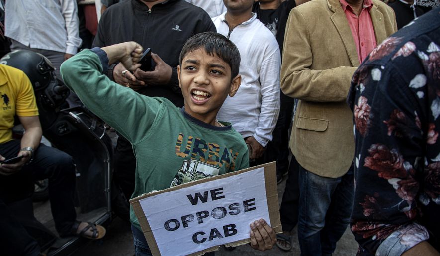An Indian boy joins in a protest rally during a shutdown against the Citizenship Amendment Bill (CAB) in Gauhati, India, Tuesday, Dec. 10, 2019. Opponents of legislation that would grant Indian citizenship to non-Muslim illegal migrants from Pakistan, Bangladesh and Afghanistan have enforced an 11-hour shutdown across India's northeastern region. (AP Photo/Anupam Nath)
