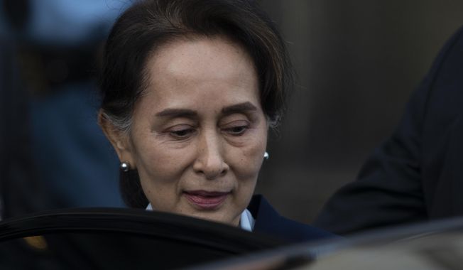 Myanmar&#x27;s leader Aung San Suu Kyi leaves the International Court of Justice after addressing judges on the second day of three days of hearings in The Hague, Netherlands, Wednesday, Dec. 11, 2019. Aung San Suu Kyi defended Myanmar and denied genocide accusations in a case filed by Gambia at the ICJ, the United Nations&#x27; highest court, accusing Myanmar of genocide in its campaign against the Rohingya Muslim minority. (AP Photo/Peter Dejong)