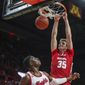 Wisconsin forward Nate Reuvers (35) dunks on Rutgers forward Shaq Carter (13) during the first half of an NCAA college basketball game in Piscataway, N.J., Wednesday, Dec. 11, 2019. (Andrew Mills/NJ Advance Media via AP)