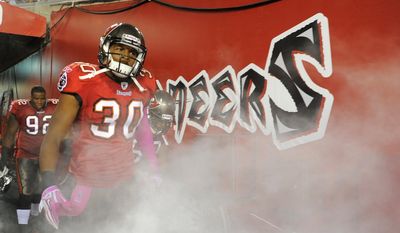 Tampa Bay Buccaneers defensive back Devin Holland (30) comes out of the tunnel at the start of NFL football game against the Indianapolis Colts on Monday, Oct. 3, 2011, in Tampa, Fla. (AP Photo/Brian Blanco)