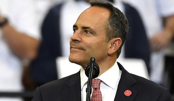 FILE - In this Nov. 4, 2019, file photo, Kentucky Gov. Matt Bevin, right, looks out at the crowd during a campaign rally with President Donald Trump in Lexington, Ky. Bevin, who lost to Democrat Andy Beshear last month in a close race, issued more than 400 pardons since the Nov. 5 election, according to the Kentucky Secretary of State&#39;s office.  (AP Photo/Timothy D. Easley, File)