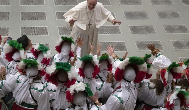 Pope Francis greets a group of Mexican pilgrims in the Paul VI Hall at the Vatican during his weekly general audience, Wednesday, Dec. 11, 2019. (AP Photo/Alessandra Tarantino)