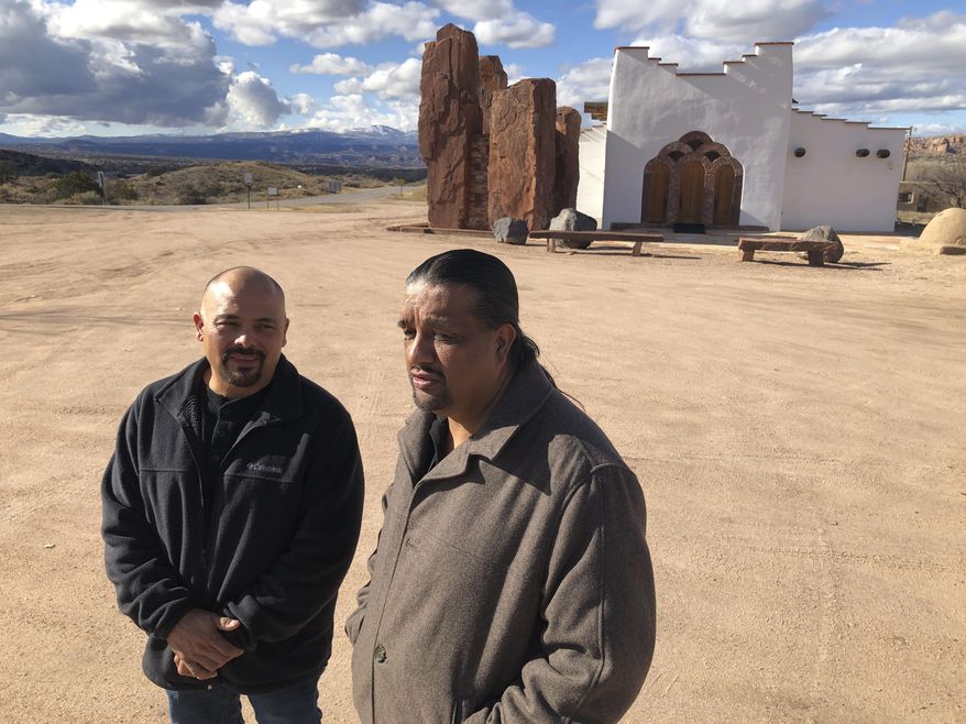 In this Dec. 9, 2019 photo, Santa Fe County Commissioner Henry Roybal, left, and Pojoaque Pueblo special projects coordinator Gabriel Montoya, right, pose for a photo near a nondenominational sanctuary in Pojoaque, N.M. As the 2020 census approaches, an Associated Press analysis of government data has found that about 41% of New Mexico residents live in hard-to-count areas —the largest proportion of any state in the nation. Roybal recruited Montoya as a trusted voice in the Native American community to promote census participation, which could help with the allocation of $1.5 trillion in federal spending. (AP Photo/Morgan Lee)