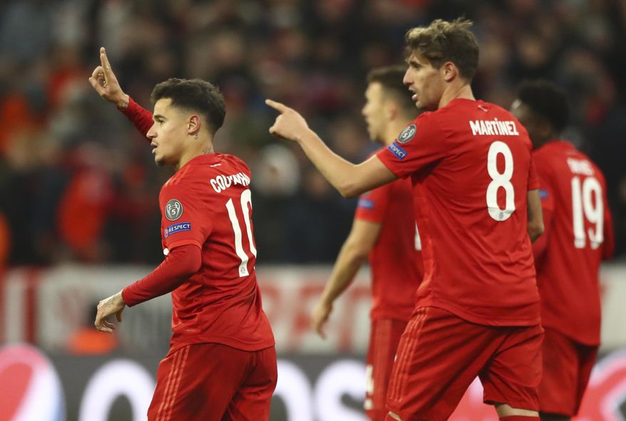 Bayern's Philippe Coutinho, left, celebrates with teammates after scoring his sides third goal during the Champions League group B soccer match between Bayern Munich and Tottenham Hotspur at the Allianz Arena stadium, in Munich, Wednesday, Dec. 11, 2019. (AP Photo/Matthias Schrader)