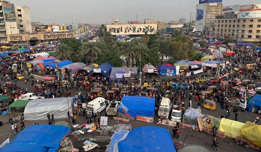 Anti-government protesters gather in Tahrir Square during ongoing protests in Baghdad, Iraq, Tuesday, Dec. 10, 2019. (AP Photo/Ali Abdul Hassan)