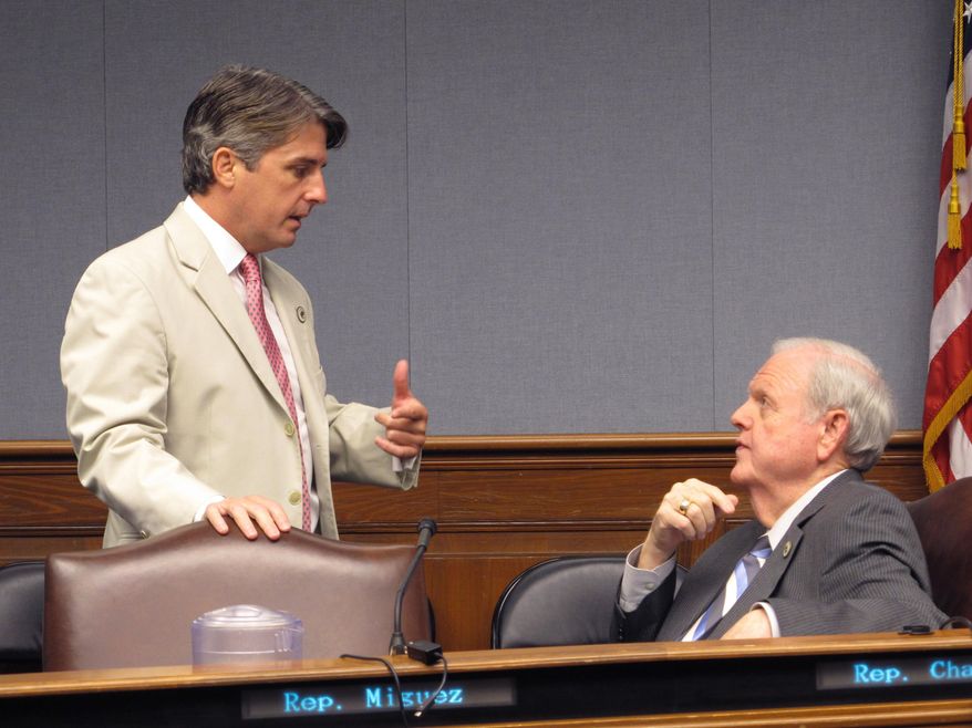 File-This June 19, 2018, file photo shows appropriations Chairman Cameron Henry, R-Metairie, standing, speaks with Rep. Charles "Bubba" Chaney, R-Rayville, in the House Appropriations Committee in Baton Rouge, La. Louisiana's income forecasting panel is expected Thursday, Dec. 12, 2019, to revise its forecasts for the upcoming budget year, possibly giving the governor and lawmakers more money to spend on an ever-growing list of proposals. (AP Photo/Melinda Deslatte, File)