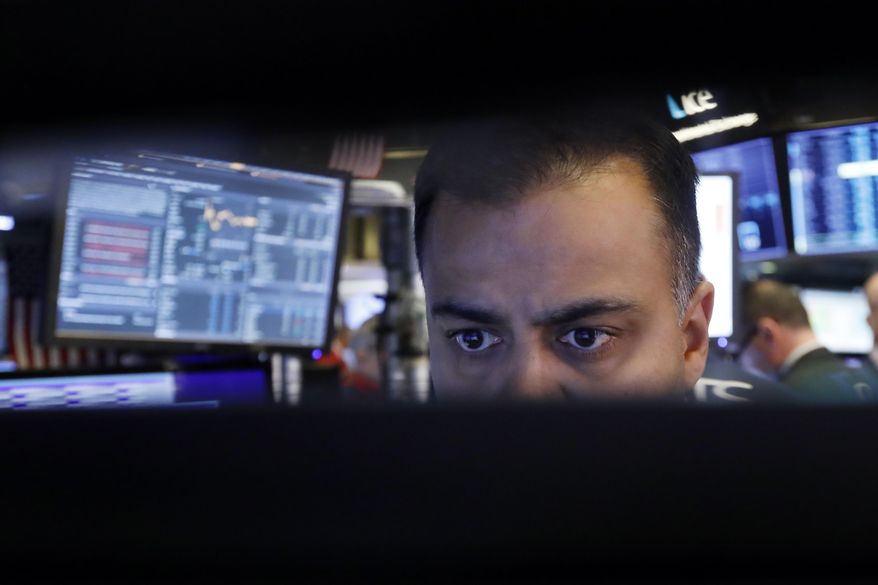 FILE - In this Nov. 20, 2019, file photo specialist Dilip Patel watches the screens at his post on the floor of the New York Stock Exchange. Small and mid-cap stocks have been largely overlooked by many investors this year as the larger indexes surge, but they could be poised for a breakout year. (AP Photo/Richard Drew, File)