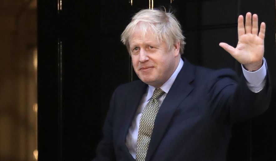 Britain&#39;s Prime Minister Boris Johnson waves on the steps after speaking outside 10 Downing Street in London on Friday, Dec. 13, 2019. Boris Johnson&#39;s gamble on early elections paid off as voters gave the UK prime minister a commanding majority to take the country out of the European Union by the end of January, a decisive result after more than three years of stalemate over Brexit. (AP Photo/Matt Dunham)
