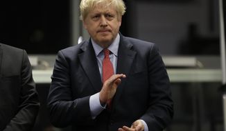 Britain&#39;s Prime Minister and Conservative Party leader Boris Johnson applauds during the Uxbridge and South Ruislip constituency count declaration at Brunel University in Uxbridge, London, Friday, Dec. 13, 2019. (AP Photo/Kirsty Wigglesworth)
