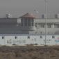 In this Monday, Dec. 3, 2018, photo, a guard tower and barbed wire fences are seen around a facility in the Kunshan Industrial Park in Artux in western China&#39;s Xinjiang region. People in touch with state employees in China say the government in the far west region of Xinjiang is destroying documents and taking other steps to tighten control on information. (AP Photo/Ng Han Guan, File)