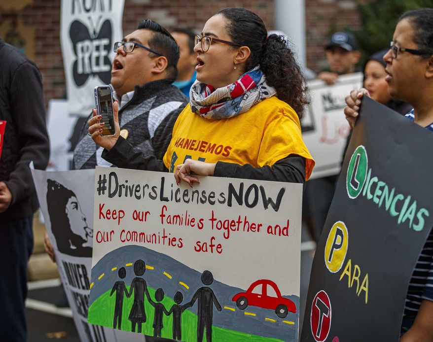 Karina Dominguez, 24, Pleasantville holds a #DriversLicensesNow sign during the rally. Immigrant activists were rallying Tuesday, Dec. 10, 2019, in Northfield, N.J., in front of the offices of Assemblyman Vince Mazzeo and Assemblyman John Armato about Drivers Licenses For Immigrants. (Craig Matthews/The Press of Atlantic City via AP)