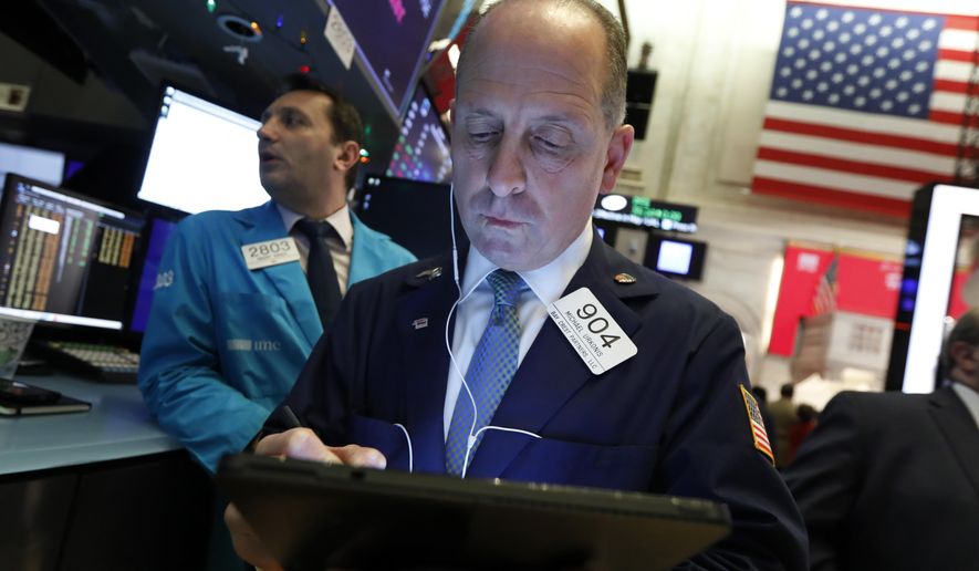 FILE - In this Dec. 5, 2019, file photo trader Michael Urkonis works on the floor of the New York Stock Exchange. The U.S. stock market opens at 9:30 a.m. EST on Friday, Dec. 13. (AP Photo/Richard Drew, File)