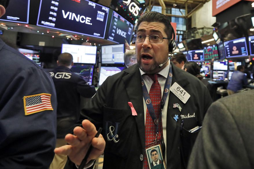 Trader Michael Capolino works on the floor of the New York Stock Exchange, Friday, Dec. 13, 2019. (AP Photo/Richard Drew) ** FILE **