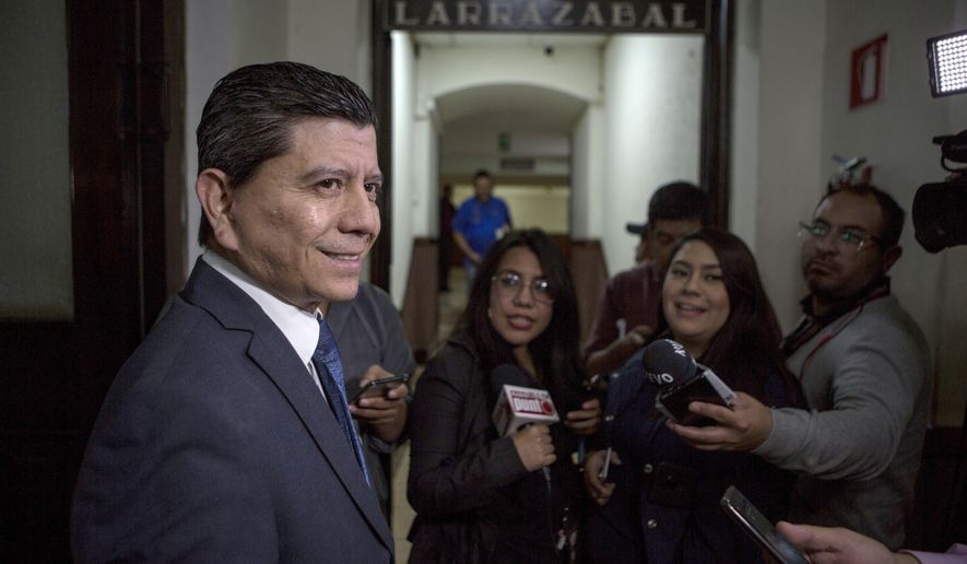 Guatemalan congressman Juan Ramon Lau, answers questions from journalists before starting a session of Congress in Guatemala City, Wednesday, Dec. 11, 2019. Lau is presiding over the commission that is investigation the U.N.-sponsored anti-graft commission, CICIG, and said it has heard from more than 20 people who say they were victimized by CIGIC and about 40 are expected to appear before it wraps up. (AP Photo/Oliver de Ros)