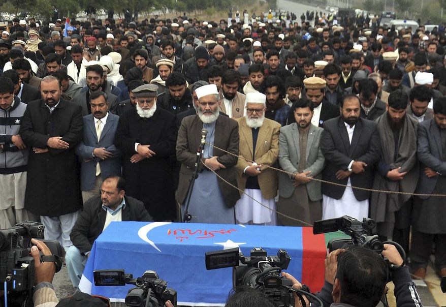 Supporters of Pakistani religious party offer funeral prayers of a student lost his life during a clash in university in Islamabad, Pakistan, Friday, Dec. 13, 2019. Authorities in Pakistan's capital Islamabad on Friday temporarily closed a major university following overnight armed clashes between rival groups that left one student dead and and several others wounded. (AP Photo/B.K. Bangash)
